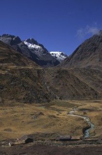 BOLIVIA, Cordillera Norte , Settlement with mountains behind with snow on the peaks.