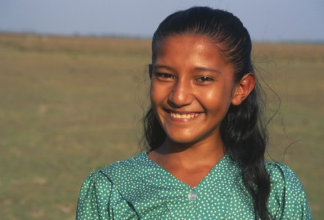 COLOMBIA, Casanare, A Llanera girl wearing a green top with white dots.
