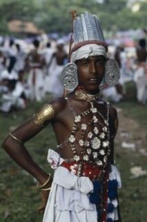 SRI LANKA, Kandy, Portrait of young man dressed for Kandy Esala Perahera.  Procession to honour