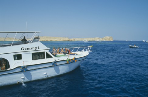 EGYPT, Red Sea Coast, Ras Mohammed, Divers prepare to dive off boat.