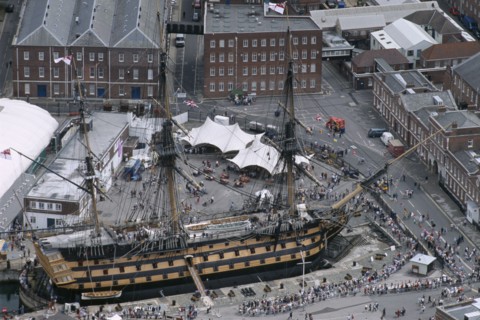 ENGLAND, Hampshire, Portsmouth, HMS Victory. Arial view of Royal Naval Dockyard. People crowding