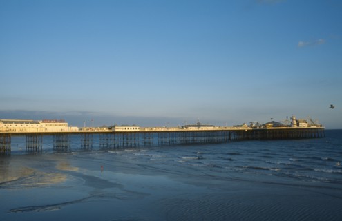 ENGLAND, East Sussex, Brighton, Brighton Pier in early evening light.