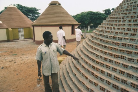 ANGOLA, Tradtional Homes, Builder working on new village housing.