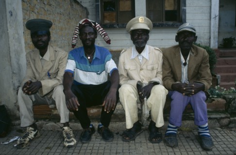ANGOLA, Malange, Four Malange chiefs seated and wearing different hats.