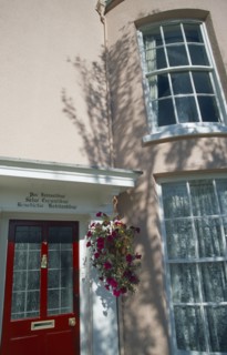 ENGLAND, Hampshire, Portsmouth, Old Portsmouth. Pink Town house with Latin Script written above red