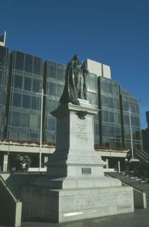 ENGLAND, Hampshire, Portsmouth, Guildhall Square. Statue of Queen Victoria with Council offices