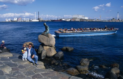 DENMARK, Zealand, Copenhagen, Family posing for photograph beside the Little Mermaid statue with