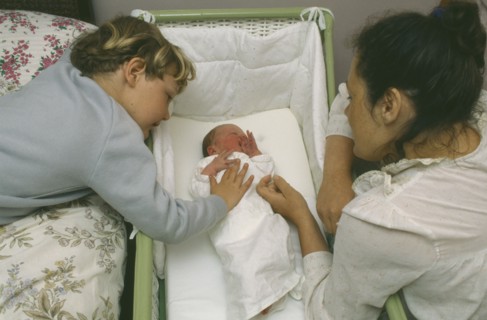 CHILDREN, Relationships, Siblings, Mother and five year old son looking at week old sister lying in