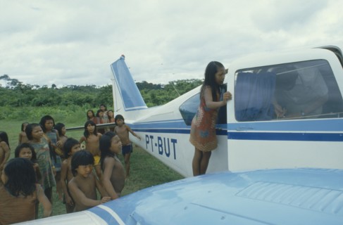 BRAZIL, Amazon, Transport, Xikrin Indian children crowding around small plane.