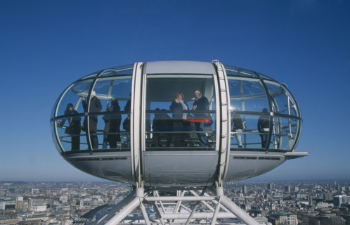 ENGLAND, London, British Airways London Eye capsule and the London skyline with tourist waving to