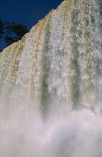 ARGENTINA, Iguazu Falls, Looking up at the water pouring over the edge with water spray.