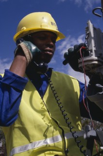 BOTSWANA, People, Work, Portrait of trainee electrical engineer working on terminal box.