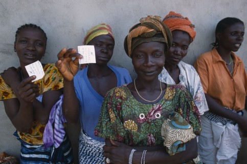 GUINEA, People, Women, Sierra Leonean refugees queuing for food rations at Kissidougou camp.