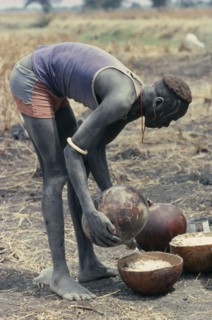SUDAN, Tribal People, Preparation of millet porridge for Dinka wedding feast.