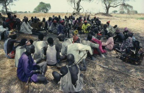 SUDAN, Tribal People, Guests at Dinka wedding listening to traditional story teller.