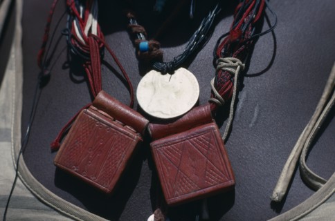 SUDAN, Mornei Settlement, Close view of leather pouches containing verses of the Koran worn as a