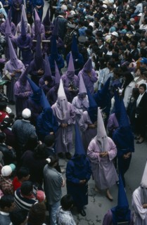 ECUADOR, Quito, Good Friday procession in Plaza San Francisco.  Penitents wearing purple robes and