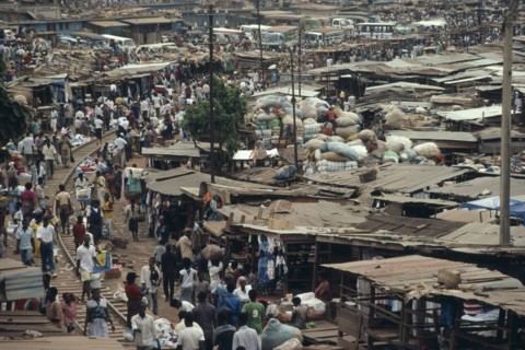 GHANA, Ashanti Region, Kumasi, "Busy market square with traffic, crowds of people and tin roofed