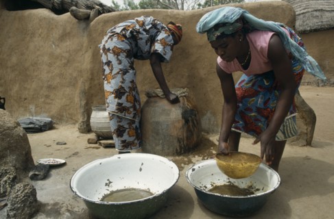 GHANA, Water, "Women filtering water to prevent guinea worm, a parasitic disease contracted when