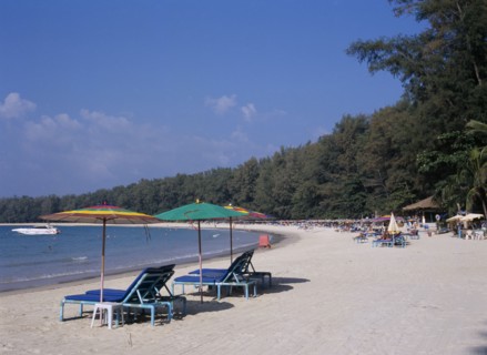 THAILAND, North Phuket, Naiyang Beach, "View along the sandy beach with sun loungers and colourful