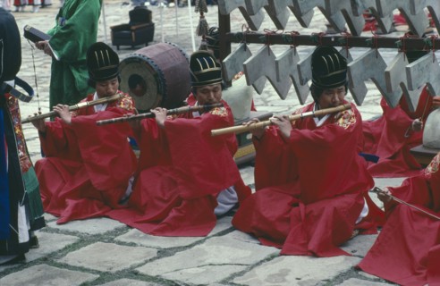 SOUTH KOREA, Religion, Buddhism, Confucian Rites Orchestra. Line of men in red robes sat on ground