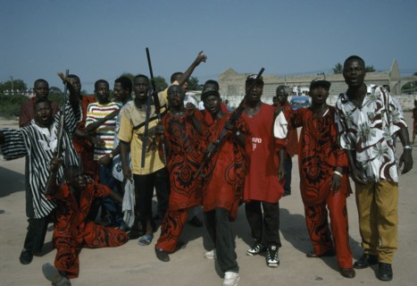 GHANA, Accra, Burial of an engineer.  The Asafo royal family guard call on the spirit of the dead