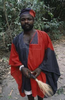 GHANA, Tribal People, Portrait of traditional priest and healer in village near Accra wearing black