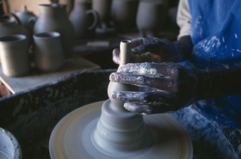 MALAWI, Dedza, Dedza Potteries producing Fair Trade goods for export.  Cropped view of potter