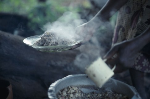 KENYA, Food, "Cropped view of woman holding plate of cooked beans, the staple diet of the Kambas,