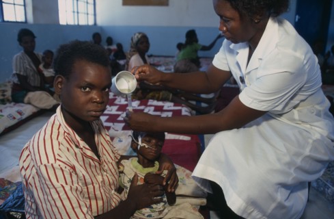 ZAMBIA, Mayukwayukwa Camp, Nurse feeding child through tube in day feeding centre for malnourished