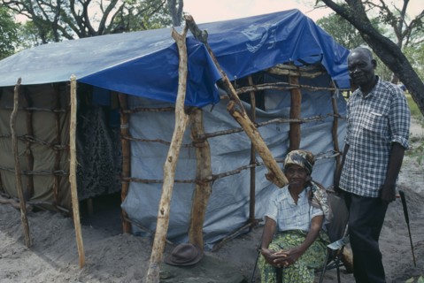 ZAMBIA, Mayukwayukwa Camp, Elderly couple beside shelter in camp for Angolan refugees.