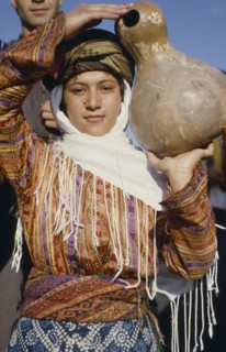 TURKEY, East, Young woman carrying calabash gourd for water.