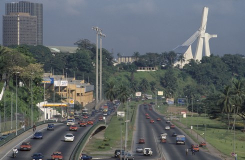 IVORY COAST, Abidjan, Cityscape with multi-lane traffic and modern exterior of St Paul’s Cathedral