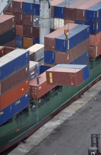 IVORY COAST, San Pédro, Containers being unloaded from vessel docked at San Pédro port.  Worker