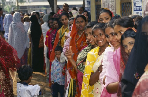 BANGLADESH, Dhaka, Crowd of women waiting in line at polling station to vote in local elections.