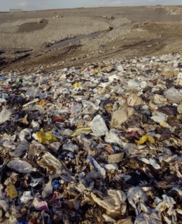 ENVIRONMENT, Rubbish, View across waste on a Infill site towards trucks used to move the rubbish