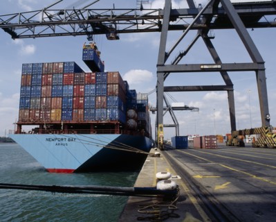INDUSTRY, Shipping, Southampton Docks. Shipping Containers being moved from ship in dock with crane