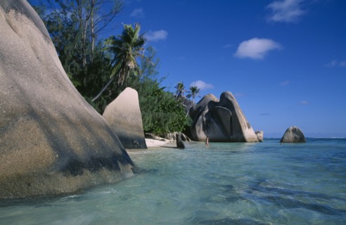 SEYCHELLES, La Digue , Anse Source D Argent, Rock formations along the coast with a woman bather