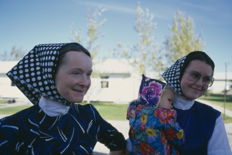 CANADA, Alberta, Hutterite women and child from the Milford farming colony near Raymond.