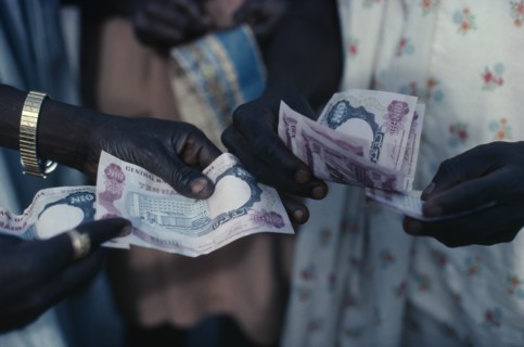NIGERIA, Money, Cropped shot of money changing hands.