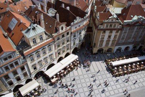 CZECH REPUBLIC, Bohemia, Prague, Restaurant and cafe tables with strolling pedestrians in the Old
