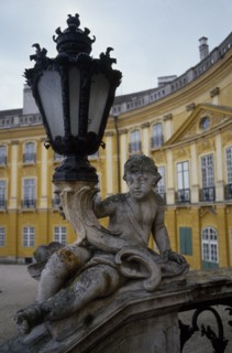 HUNGARY, Fertöd, Eszterhazy Palace, Detail of carved stone balustrade and lamp with part view of