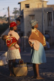 MADAGASCAR, People, Women, Road to Fianarantsoa. Two women one carrying a baby in a sling on her