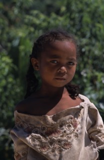 MADAGASCAR, People, Children, Road to Ambalavao. Portrait of a young girl wearing pig tails in her