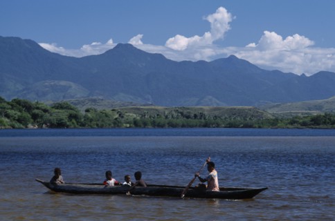 MADAGASCAR, Fort Dauphin, Lokaro, Mother ferrying her children across the bay in a Pirogue with