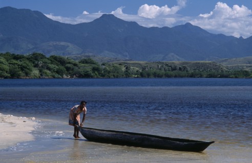 MADAGASCAR, Fort Dauphin, Lokaro, A woman standing at the waters edge of a sandy beach about to