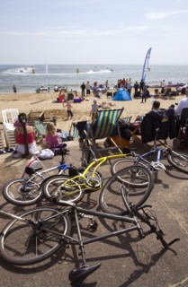 ENGLAND, Dorset, Bournemouth, Tourists watching speedboat races off the West Beach and playing in