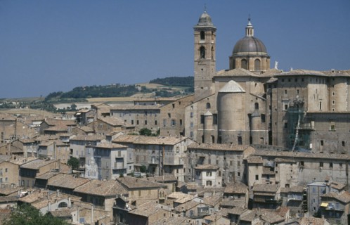 ITALY, Marche, Urbino, Palazzo Ducale rising above city rooftops.  Built for Duke Federico da