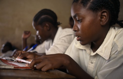 TANZANIA, Shinyanga, Schoolchildren working at desks in classroom at Mwenge Primary School.