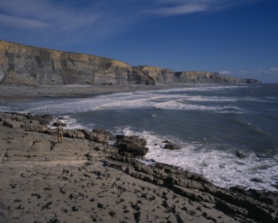 WALES, Vale of Glamorgan, Southerndown, "A man standing on the shore of the South Coast with